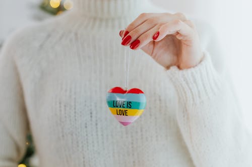 Close-Up Shot of a Person Holding a Heart-Shaped Keychain