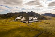 Aerial view of Hellisheidi geothermal power plant with mountains and steam in Iceland