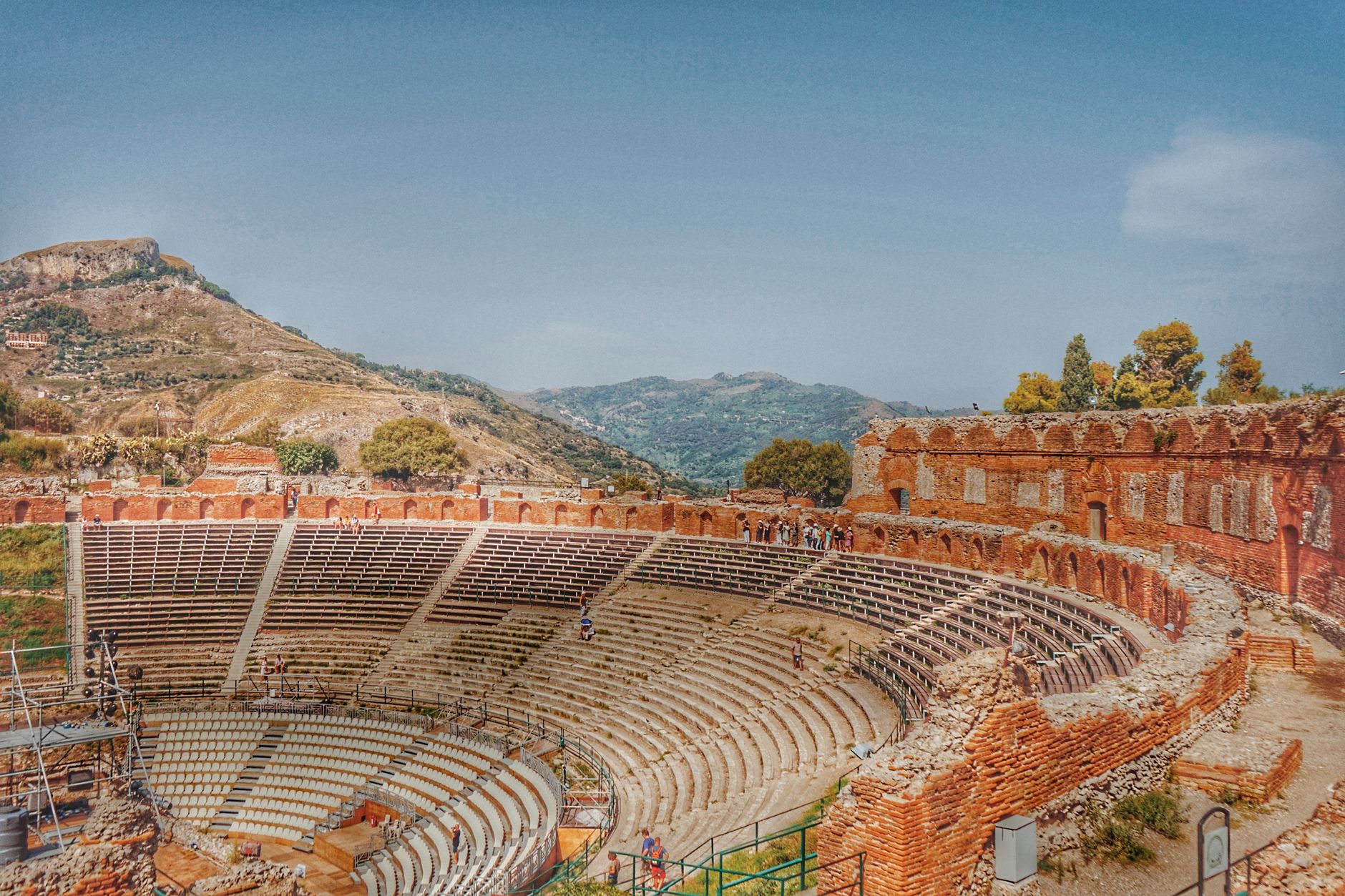 Teatro Antico di Taormina ancient theater stone in foreground with Mount Etna on the horizon