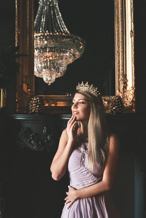 Photo of a Woman Wearing Gold Crown