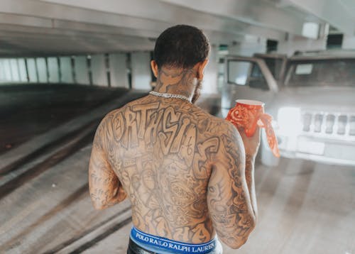 Back View of Man with Body Tattoos