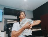 A Man Holding a Lot of Cash Money while Smoking