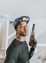 Man in Black Crew Neck Shirt Holding Black and Gray Rifle