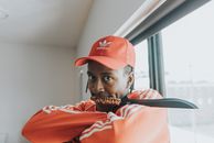 Man in Red Baseball Cap and Orange Jacket