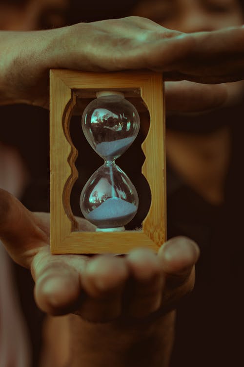 Free Clear Hourglass on Wooden Frame Stock Photo