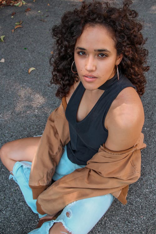 Brunette Woman Sitting on Ground