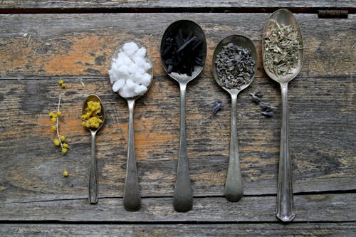 Free Spoons with Spices on Wooden Table  Stock Photo