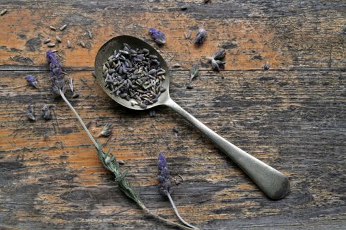 Free Close-up of lavender seeds on a vintage spoon on a wooden surface, rustic theme. Stock Photo