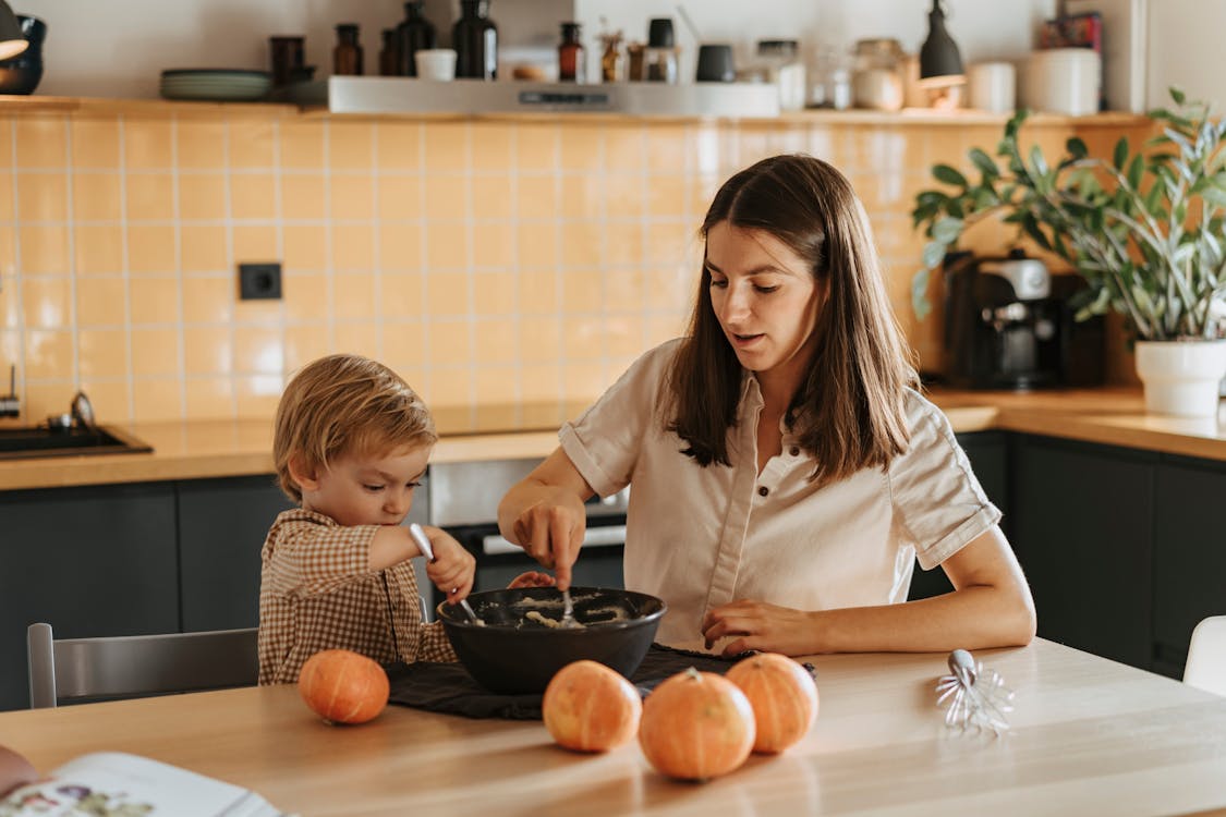 Free A Mother and Child Mixing a Dough Stock Photo