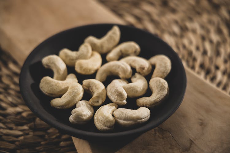 Close-Up Shot Of Cashew Nuts On Black Bowl