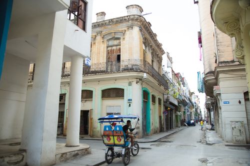 Free Exterior of aged stone residential buildings and narrow asphalt roadway situated on in old Havana city district in daylight Stock Photo