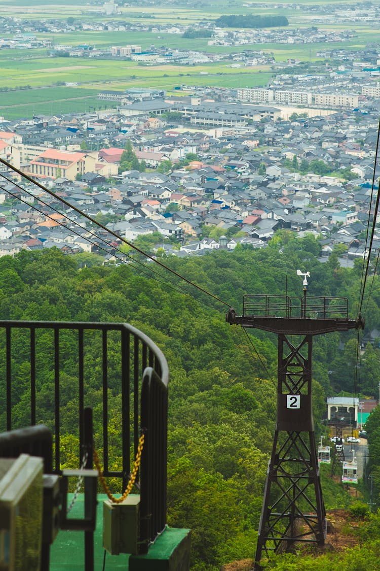 Cable Way Tower Against Modern Green City