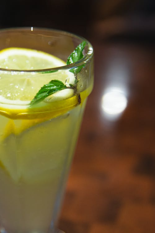 Glass of refreshing lemonade with mint and lemon