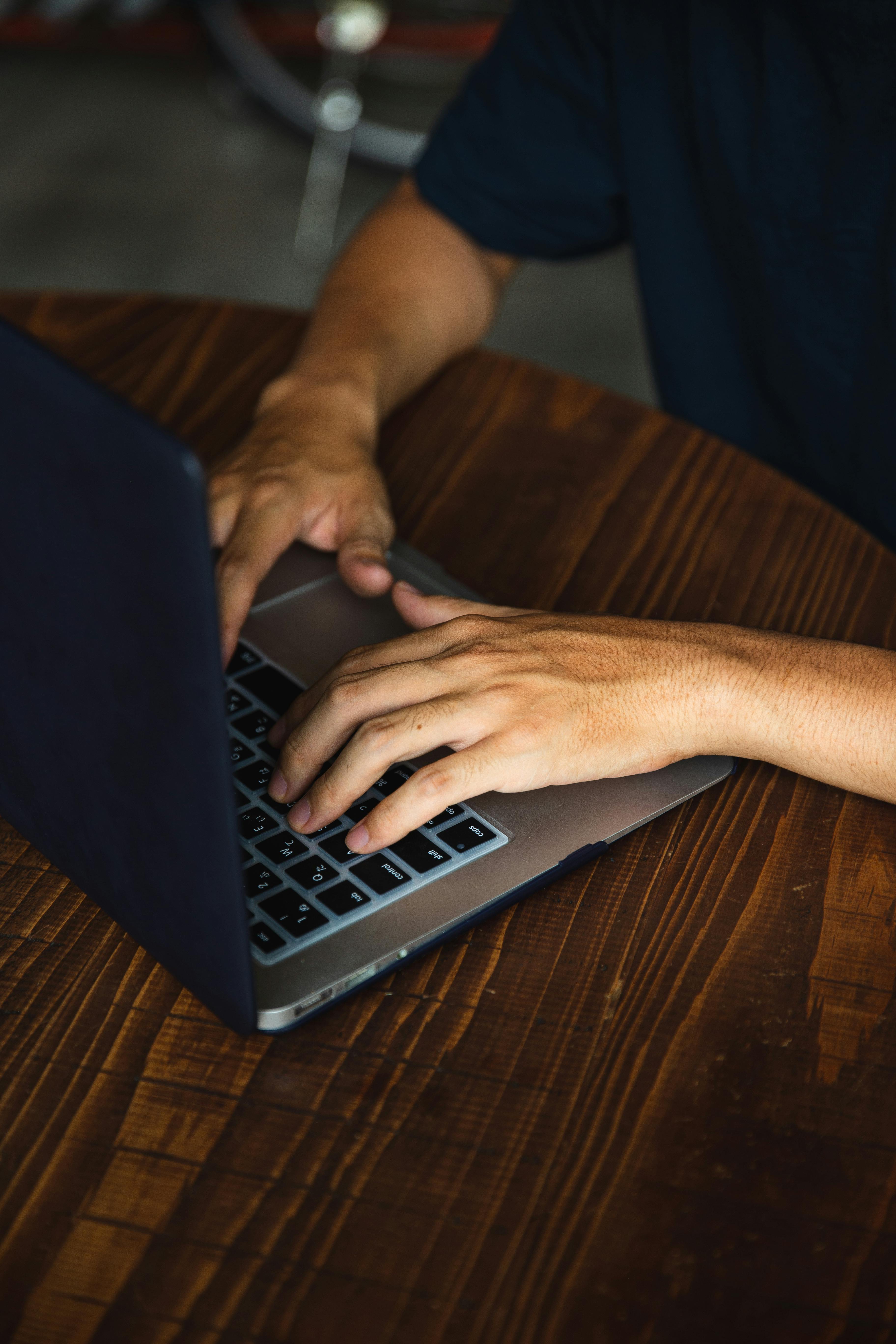 crop unrecognizable man using contemporary laptop