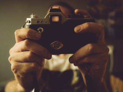 A Person Holding an Analog Camera