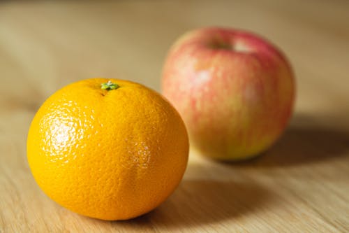 Free Ripe fresh tangerine with apple on table Stock Photo