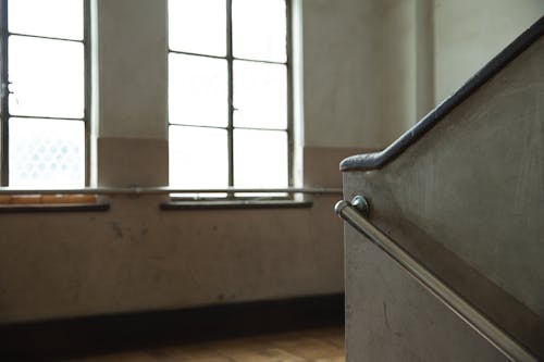 Shiny windows against concrete stair fence in building