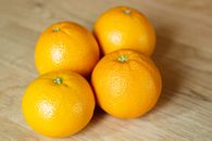From above of yummy ripe sweet tangerines with colorful shiny peel on wooden table