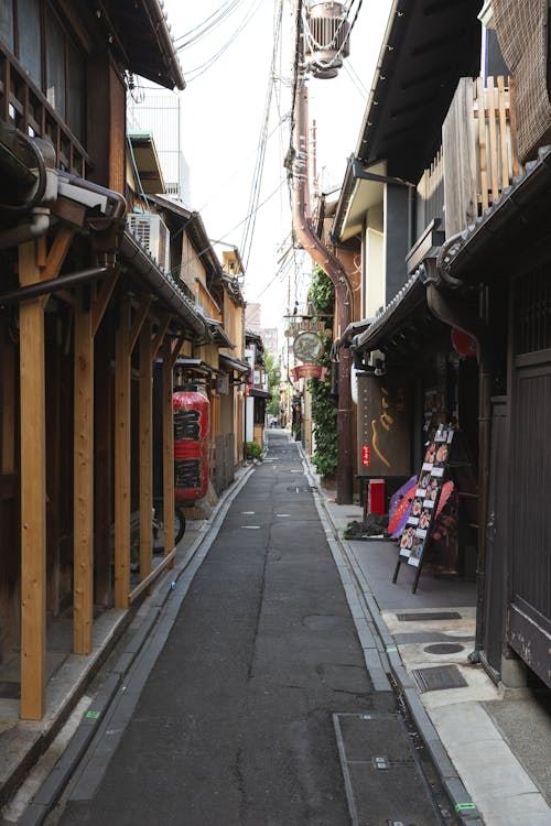 Narrow paved street with wooden houses