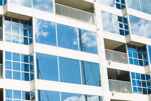 Free Building with glass windows reflecting sky Stock Photo