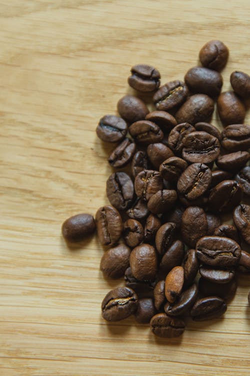 Free Roasted coffee beans scattered on table Stock Photo