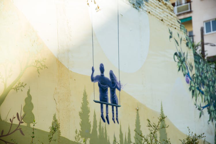 Picture Of Couple Sitting On Swing