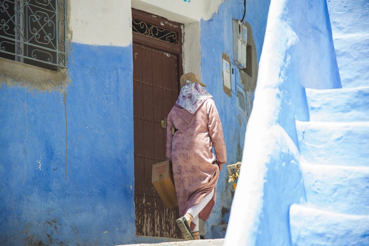 Unrecognizable Person Walking Near Old Building