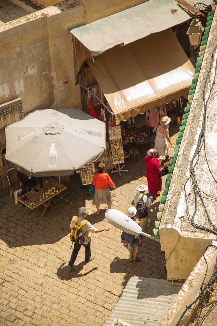 People Walking On Narrow Street