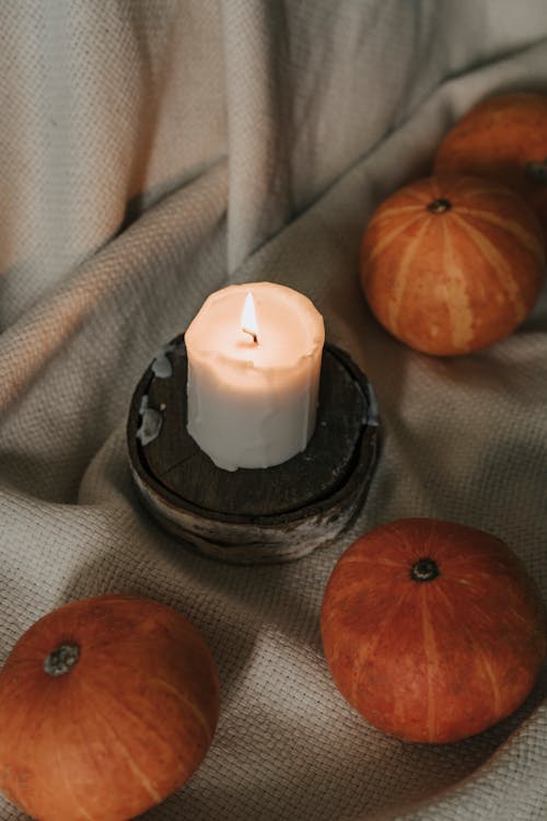 Free Small Pumpkins Beside a Lighted Candle Stock Photo