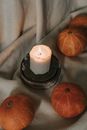 White Pillar Candle Beside Orange Pumpkin