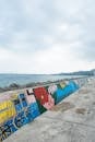 Colorful concrete fence on embankment