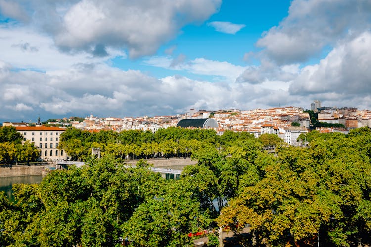 Scenic View Of Modern Low Rise City Near Vast River