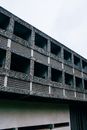 Facade of modern uncompleted concrete multistorey structure under construction beneath blue sky in town