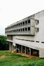 Facade of unfinished building in verdant terrain