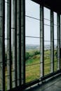 Though unfinished building window view of green hilly valley