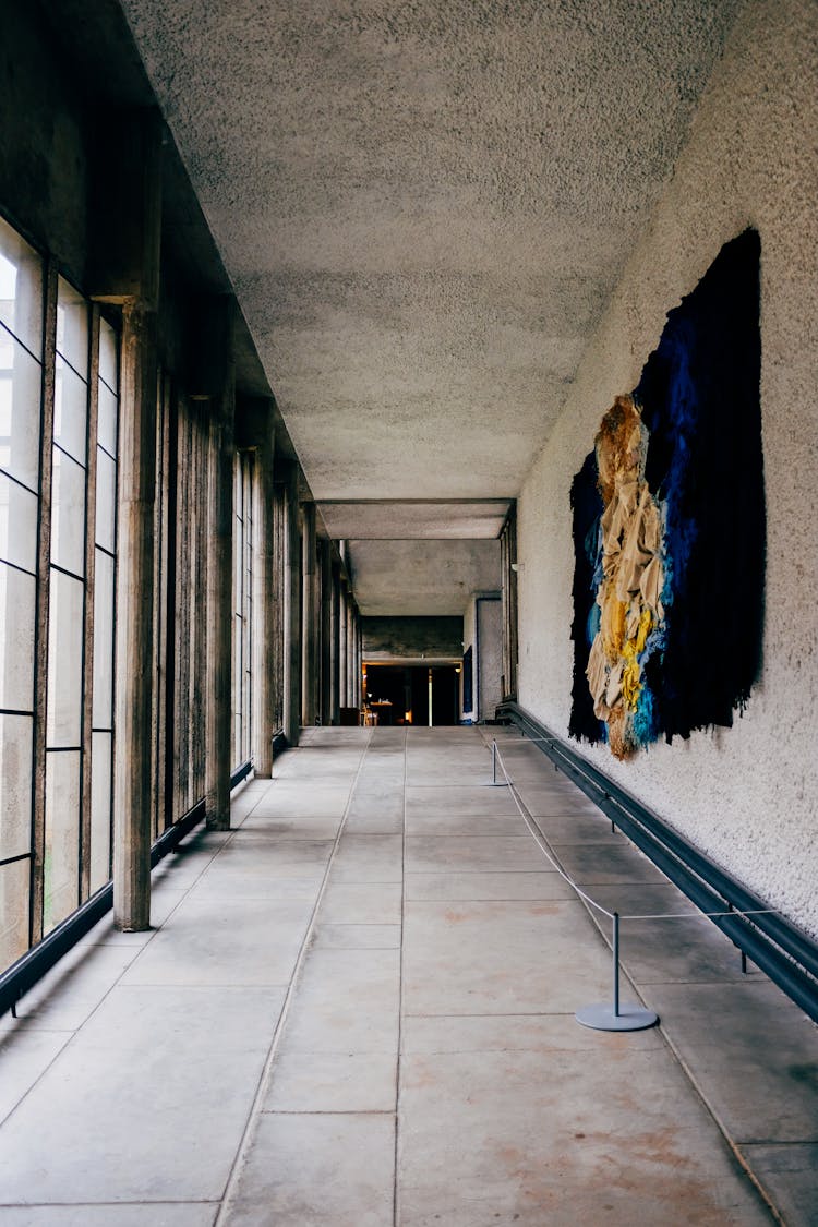 Concrete Building Corridor With Massive Painting On Wall