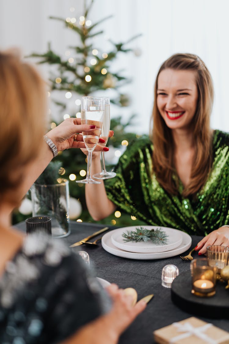 Women Drinking Wine At Dinner On Christmas 