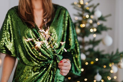 Free Woman Holding Sparkler in Hands Celebrating New Year Stock Photo
