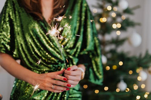 Woman in Green Dress Holding a Sparkler