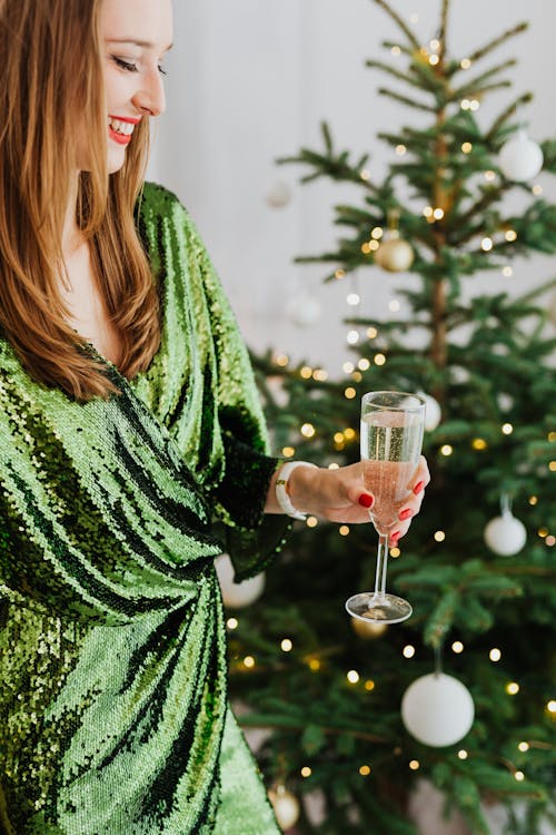 Free Woman in Green Dress Holding a Glass of White Wine Stock Photo