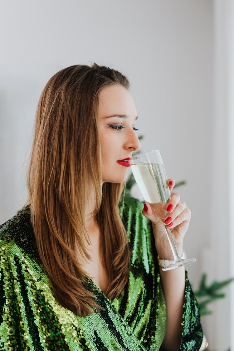 Woman Drinking A Glass Of Champagne