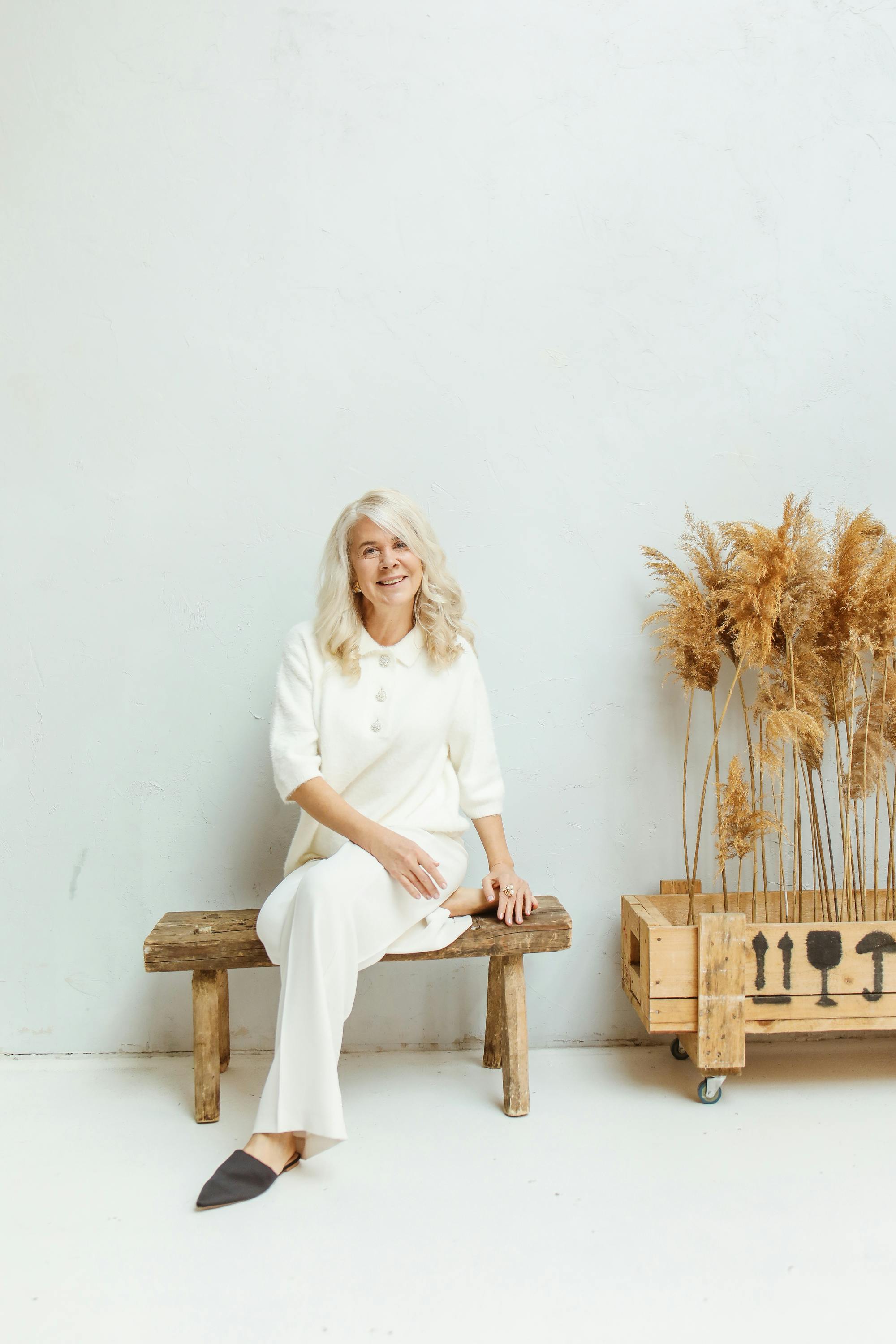 a happy elderly woman sitting on a bench