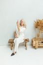 Woman in White Dress Sitting on Brown Wooden Bench