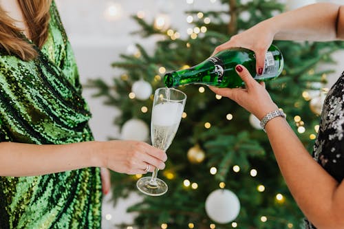 Free Close-Up Photo of Person Pouring a Champagne into a Wine Glass Stock Photo