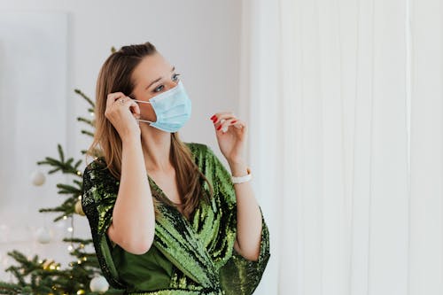 Free Woman in Green Dress Wearing a Face Mask Stock Photo
