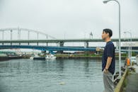 Young man smoking near river
