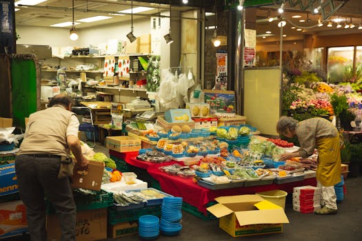 Arranged colorful containers with healthy vegetables and juicy fruits on lightened stall in market