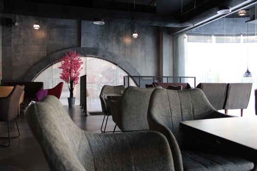 Sophisticated café interior featuring modern seating, stylish design, and ambient lighting.