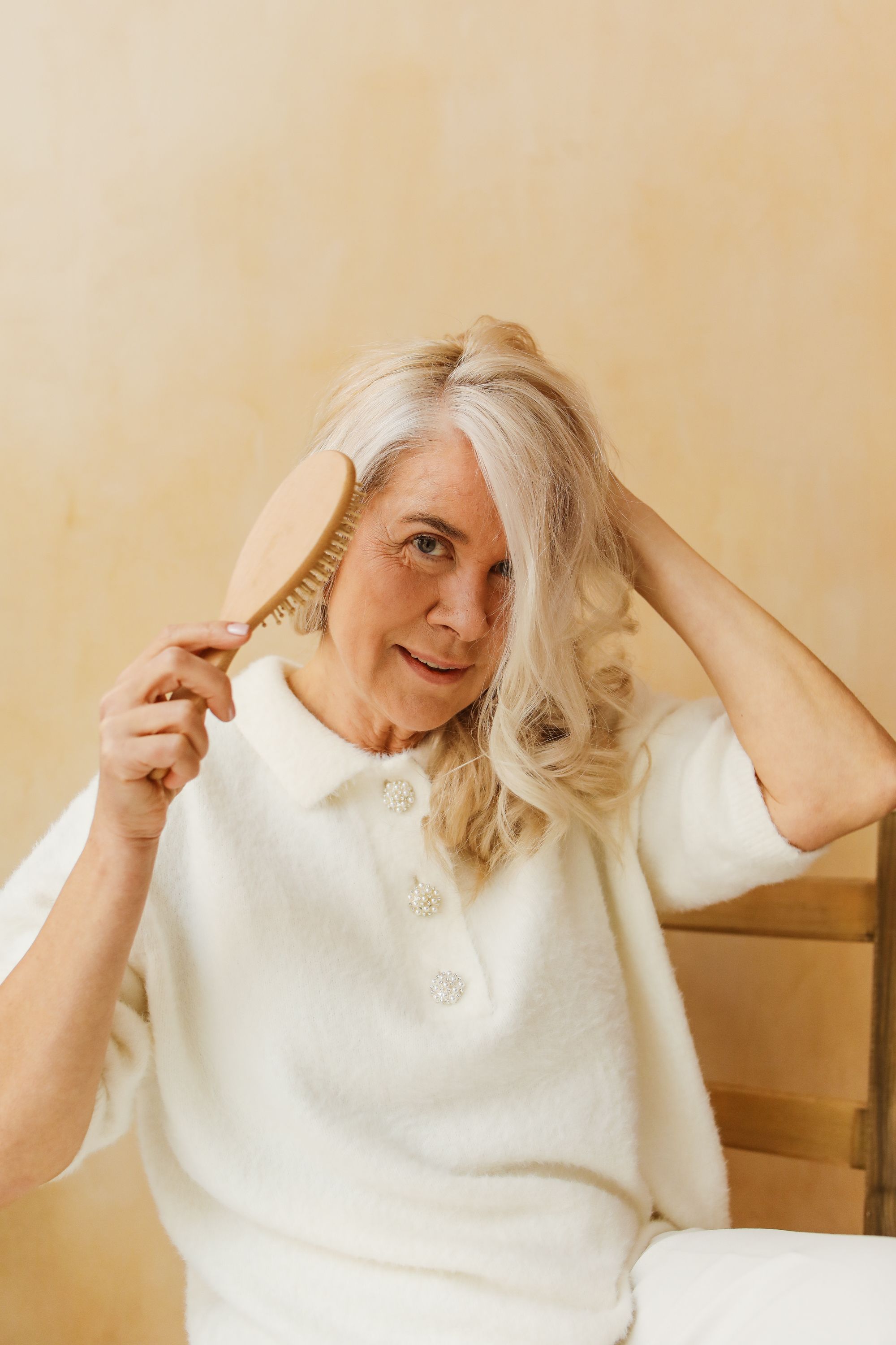Senior woman brushing her hair