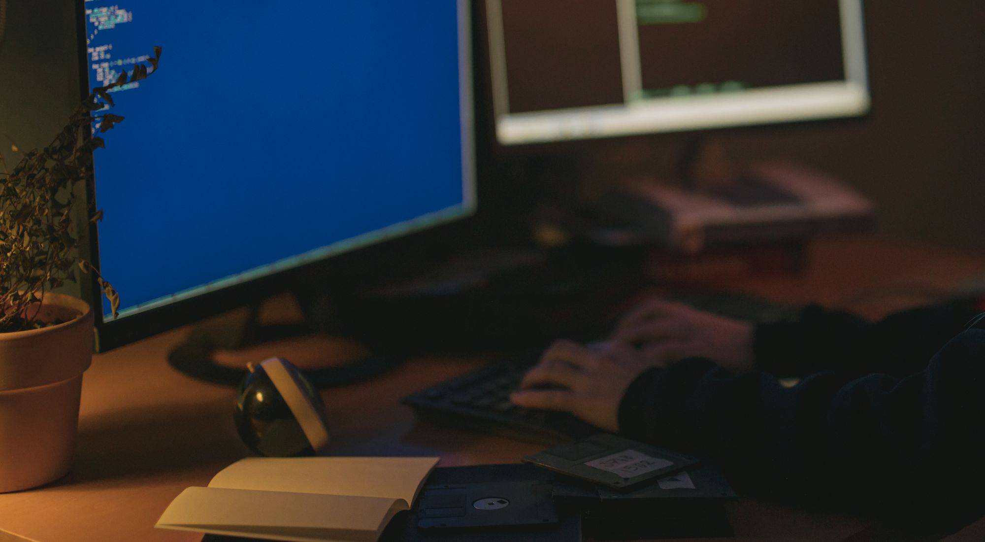 Engineers working at screens in a low-lit room